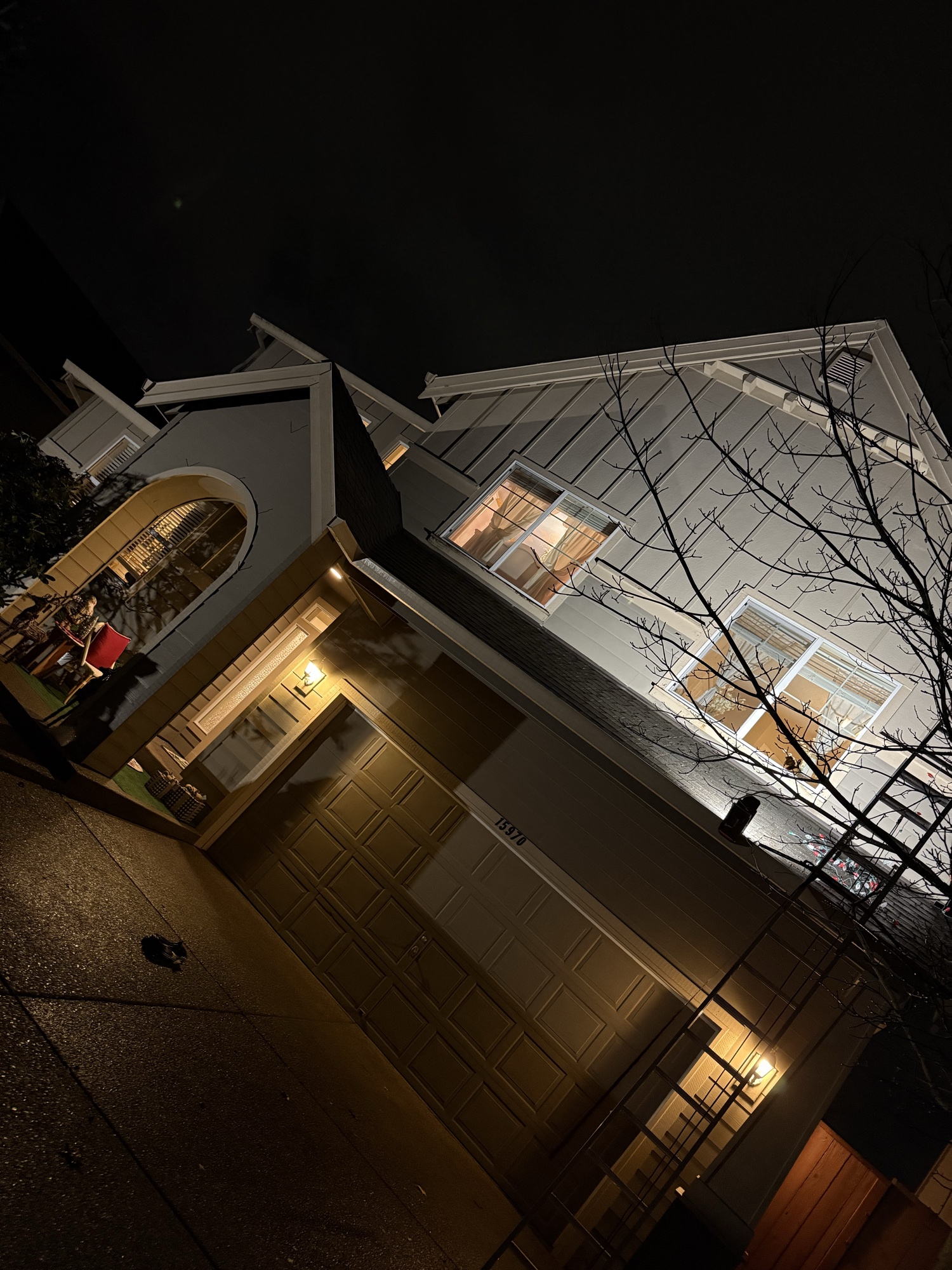 Night view of home with clean gutters and holiday lights installed